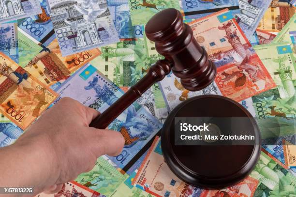 Judges Gavel And Kazakhstani Coin In Denominations Of 100 Tenge Against The Background Of Kazakhstani Tenge Stock Photo - Download Image Now