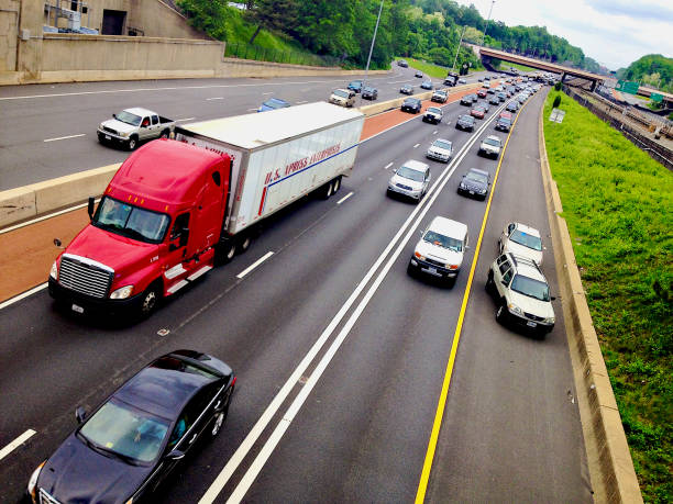 Vienna, Virginia, USA - May 15, 2014: Heavy traffic flows on Interstate 66 westbound during afternoon rush hour as an undercover Virginia State Police officer pulls over a violator and the WMATA Metro train tracks can be seen in the median.