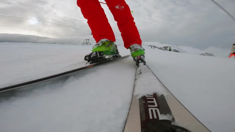 POV alpine skiing downhill on a groomed track, slow motion