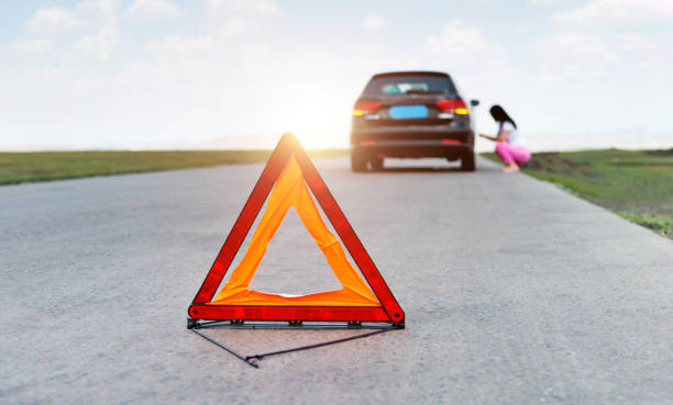 istock Red triangle sign behind the broken car 1457820278