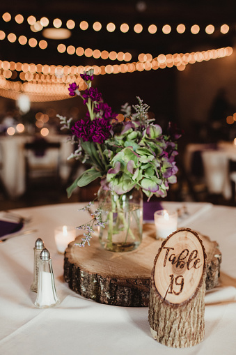 Rustic wedding centerpieces with string lights in the background