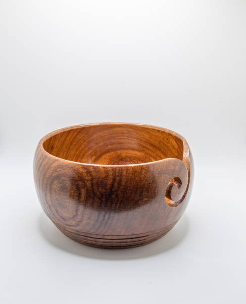 istock Wood carved yarn bowl on white background 1457824383