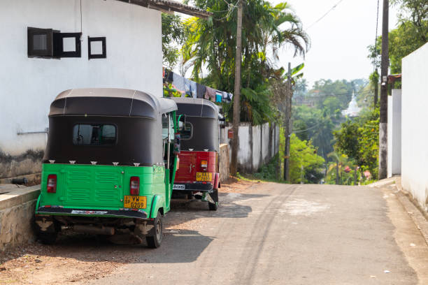 Tuk tuk cabs stand parked on a roadside, rear view Colombo, Sri Lanka - December 4, 2021: Tuk tuk cabs stand parked on a roadside, rear view taxi sri lanka stock pictures, royalty-free photos & images