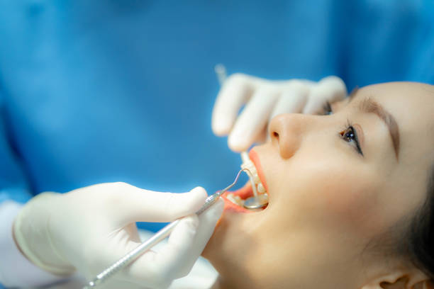istock Doctor examining patient's teeth, Cosmetic dentistry 1457830736