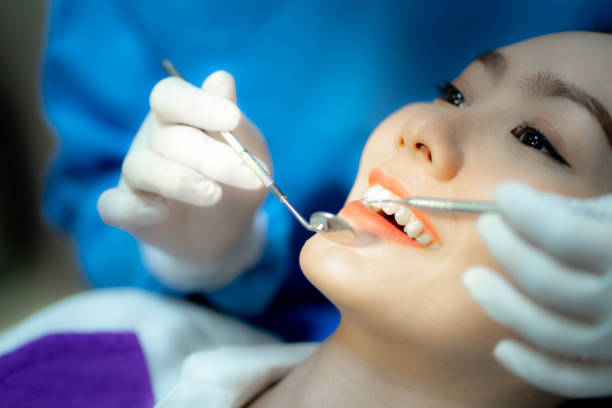 istock Asian woman checking teeth in a dentist office. 1457830740