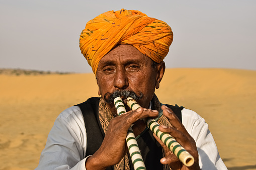 Jaisalmer Rajasthan, India 23rd January 2020 during the sunset, this man was playing a piece of beautiful folk music with two flutes together.