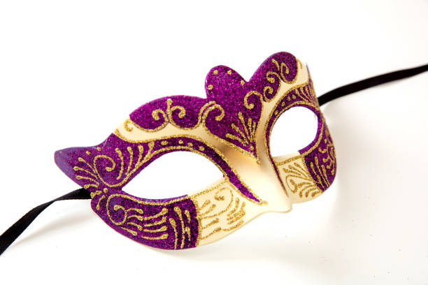 Carnival Venetian mask with purple and gold color glitter isolated on white stock photo