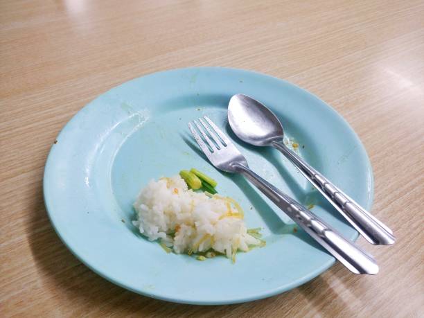 istock Leftover rice on a blue plate, finished food. 1457837853