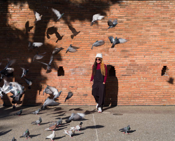 Chiang Mai, Thailand. November 12, 2022.Tourists posing with pigeons near Pratu Tha Phae Gate. Chiang Mai is northern Thailand's most colorful travel destination.