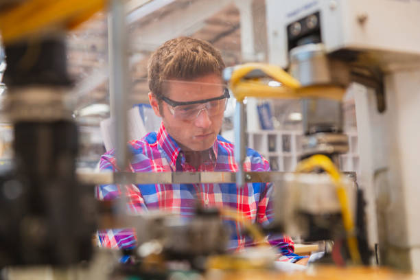 istock Young man working at manufacturing factory 1457844149