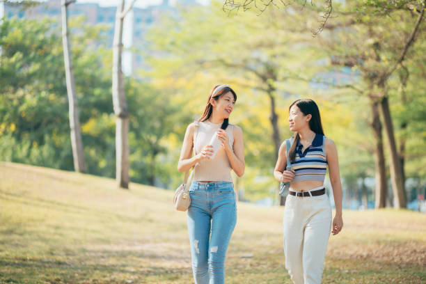 istock Two asian women chatting  in the park 1457846636
