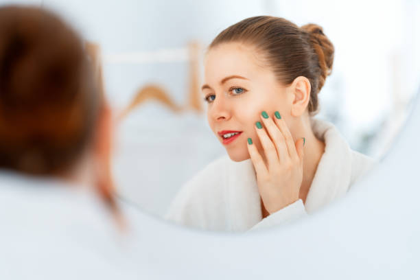 istock woman with cream for her face 1457848426