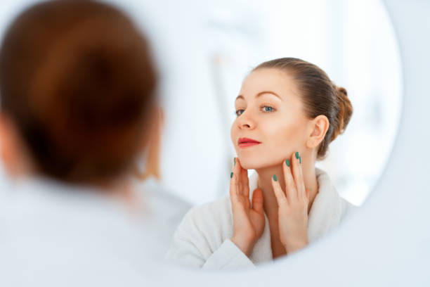 istock woman with cream for her face 1457848453