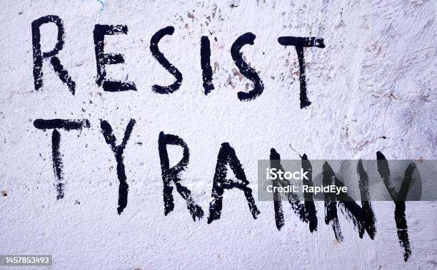 Resist Tyranny Says Graffiti Slogan Painted On Wall Stock Photo - Download Image Now