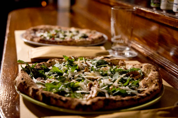 Neapolitan pizza typical Campania product with tomato and stringy morsel freshly baked and ready to be eaten served at the table