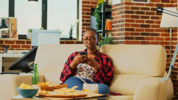 istock African american girl browsing internet on smartphone 1457854607