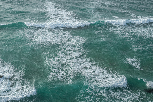 Ocean foamy pattern on water surface. Top view.