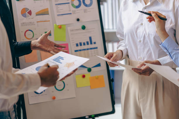 istock Intelligence analysis concept, group of business people brainstorm discussing current finance and economy on company investment laptop at meeting 1457862052