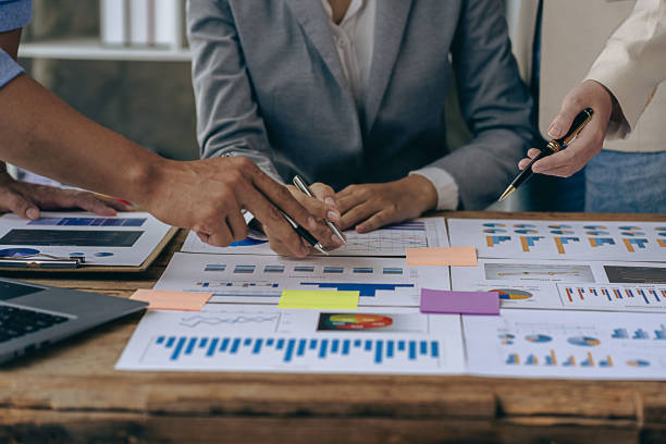 istock Intelligence analysis concept, group of business people brainstorm discussing current finance and economy on company investment laptop at meeting 1457862068