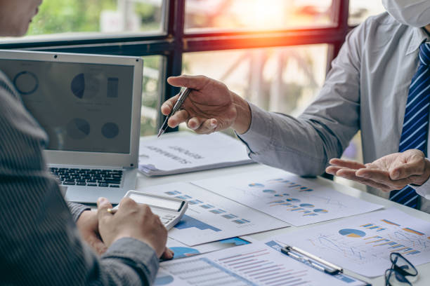 istock Intelligence analysis concept, group of business people brainstorm discussing current finance and economy on company investment laptop at meeting 1457862069