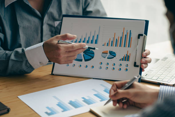 istock Intelligence analysis concept, group of business people brainstorm discussing current finance and economy on company investment laptop at meeting 1457862078