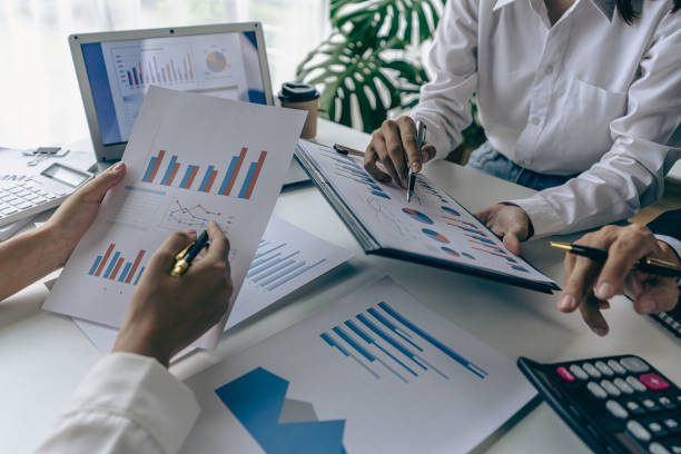 istock Intelligence analysis concept, group of business people brainstorm discussing current finance and economy on company investment laptop at meeting 1457862081