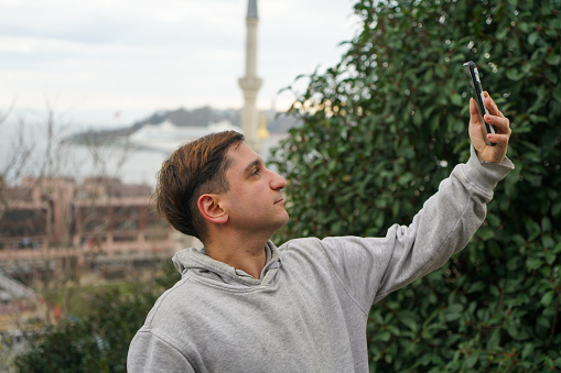 Young man is taking selfie