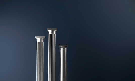 Classical architecture silver colored columns arranged as a winner podium with different heights on a dark blue background. Three elements, with shaft, capital and abacus. Copy space on right side. Digitally generated image.