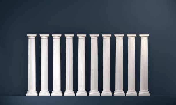 istock Ten classical style white columns aligned on a dark blue background 1457869212