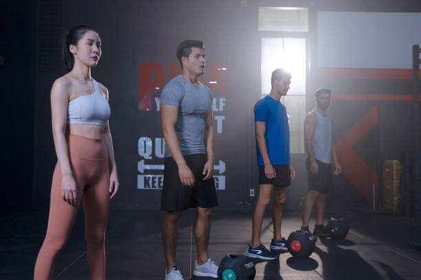 exercising at gym. - body care asian ethnicity body building toughness imagens e fotografias de stock