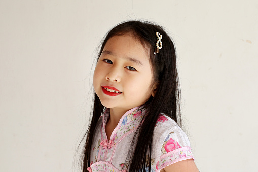Portrait of Asian girl in traditional Chinese cheongsam attire