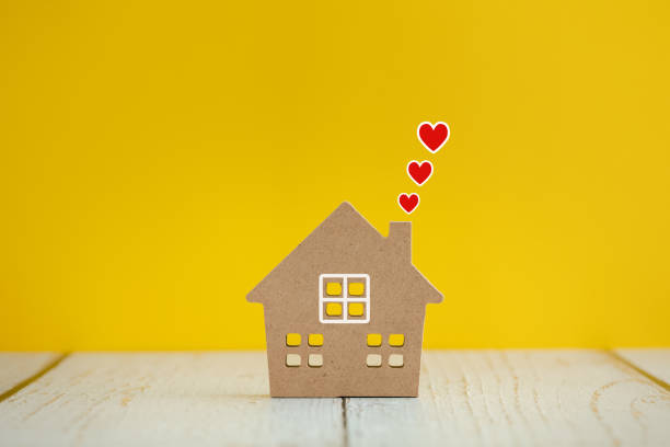 istock home model with red hearts above on yellow color background 1457875741