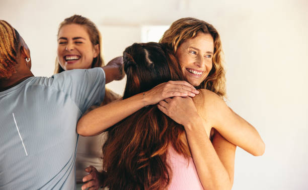 istock Group of happy people hugging each other after a yoga class 1457877544