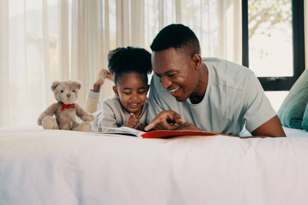 istock Daddy reads a story with his daughter at home 1457877977