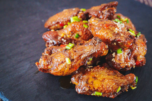 istock fried chicken with garlic and sesame in caramel on a black tray. 1457882884