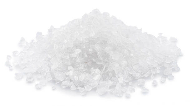 istock Pile of salt crystals on white background. File contains clipping path. 1457883048