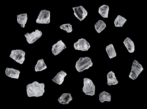 Salt crystals on black background. File contains clipping path.