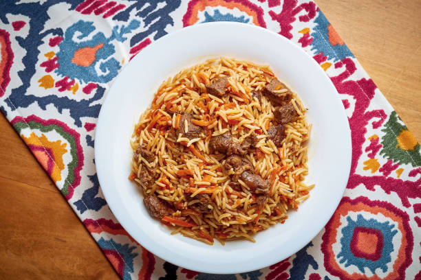 Classic oriental pilaf with meat and spices served on a plate stock photo