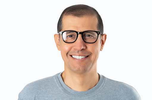 Mid adult handsome man casual t-shirt and glasses over white background happy face smiling looking at the camera. Positive person.