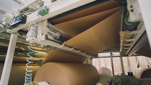 Paper industry. The paper moves automatically in the paper machine. Paper mill.