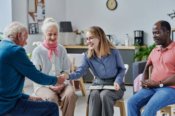istock Psychotherapist greeting senior people at therapy 1457895794