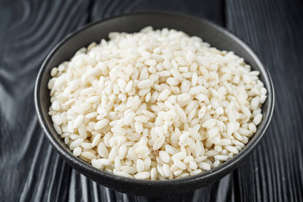 istock arborio rice for risotto on a black wooden background 1457899599