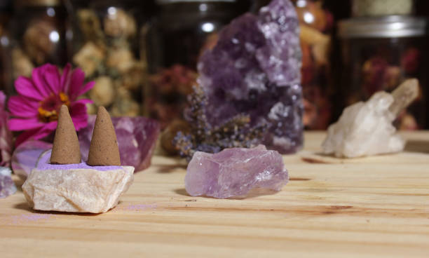 istock Amethyst Crystals With Flowers and Incense Cones on Meditation Table 1457899908