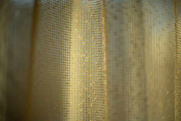 istock Curtains on window. Light through curtains. Fabric texture. structure of fine grid. 1457903974