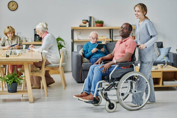 istock Volunteer working in nursing home with senior people 1457906178