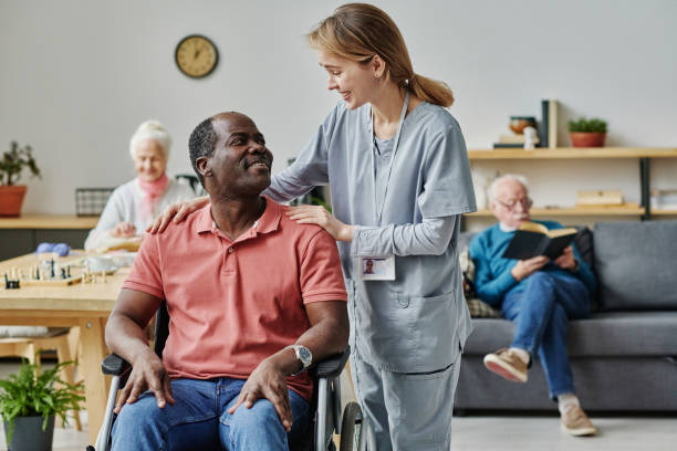 istock Volunteer talking to man with disability 1457906253