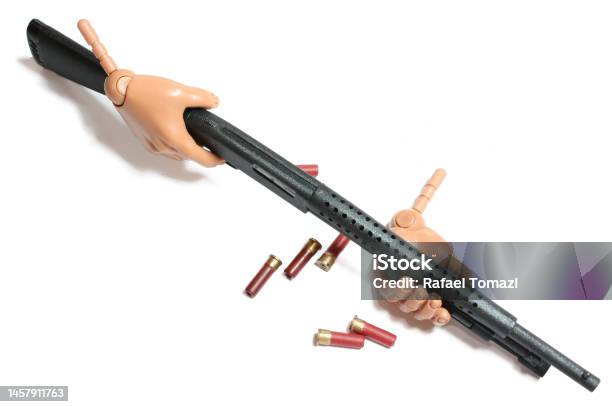 Action Figure Hand Holding Weapon In A White Background Stock Photo - Download Image Now