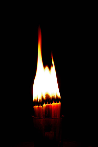 istock Burning multicolour small thin candle around dark place 1457911797
