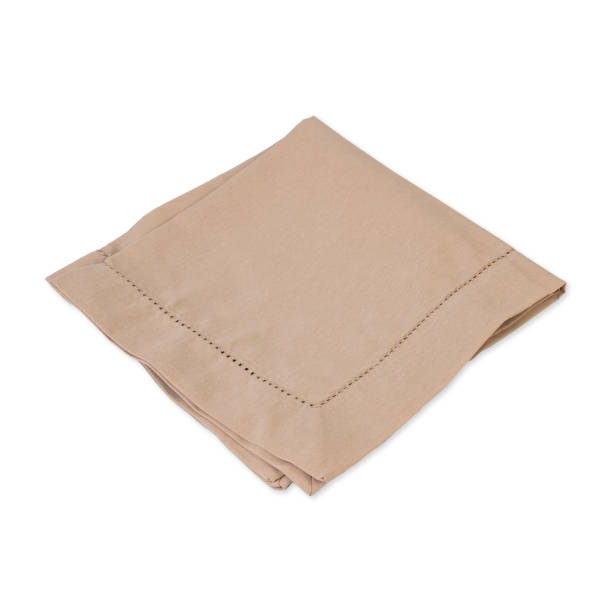 istock Folded brown tissue napkin isolated over white background 1457912113