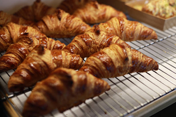 istock Freshly baked croissants on a display in bakery 1457913461